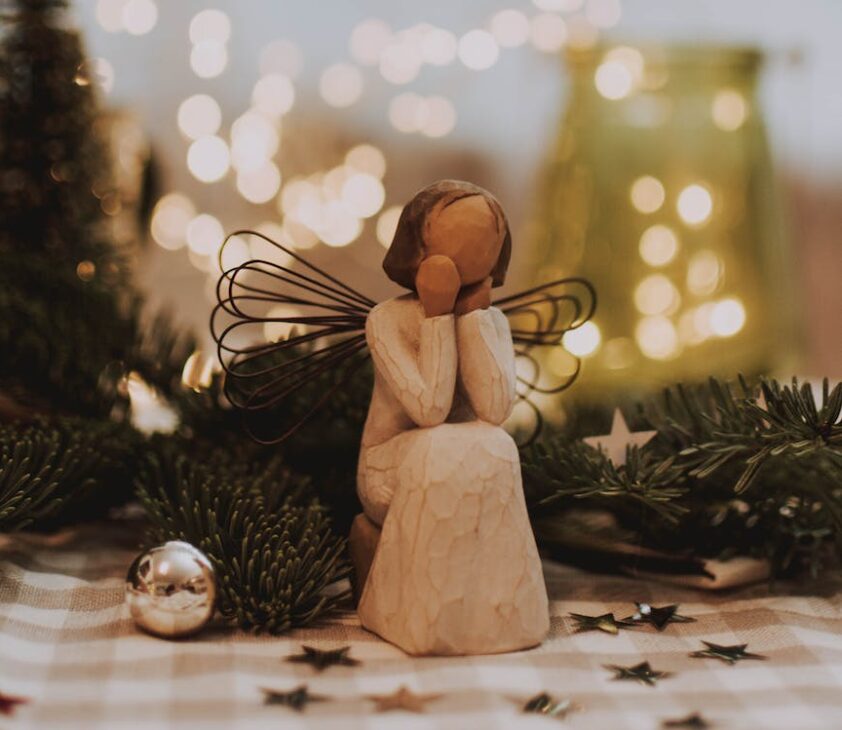 photo of angel figurine near christmas ball