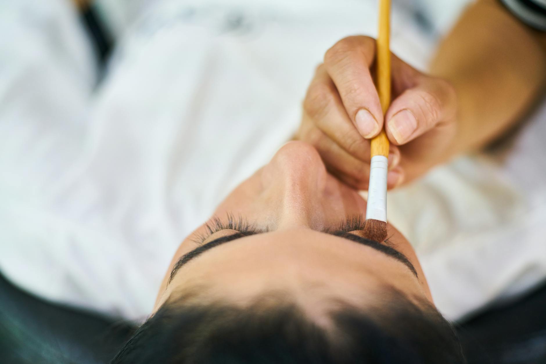 person holding makeup brush