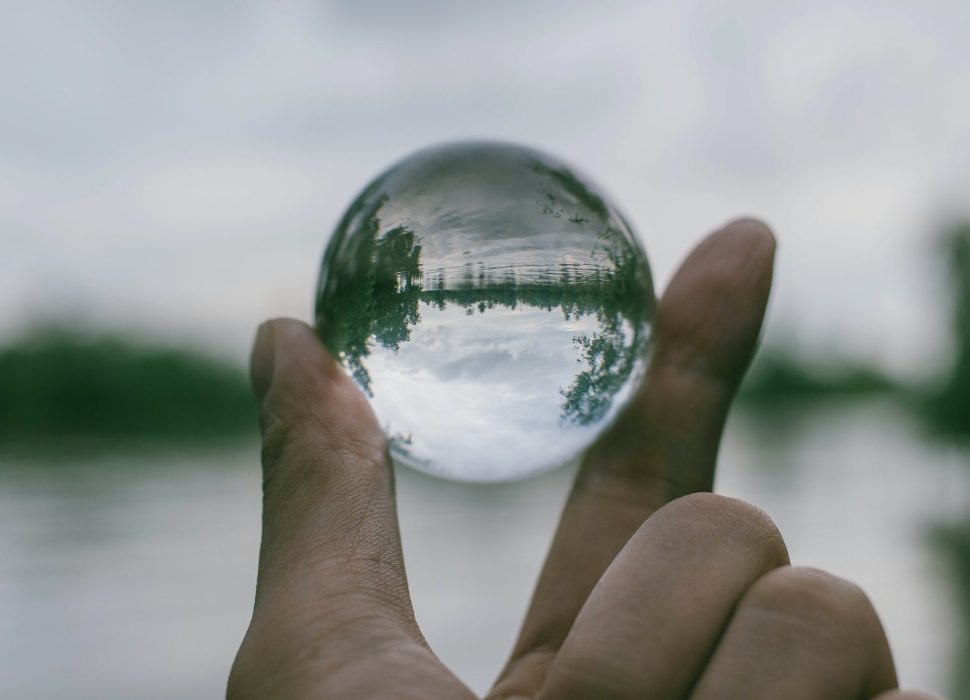 close up photography of person holding crystal ball